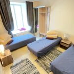 Standard private room with 3 beds, furniture, a large window