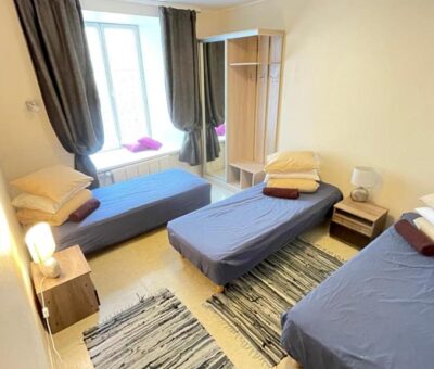 Standard private room with 3 beds, furniture, a large window