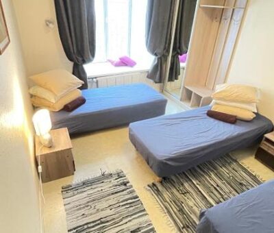 Private room with three beds, furniture, a large window